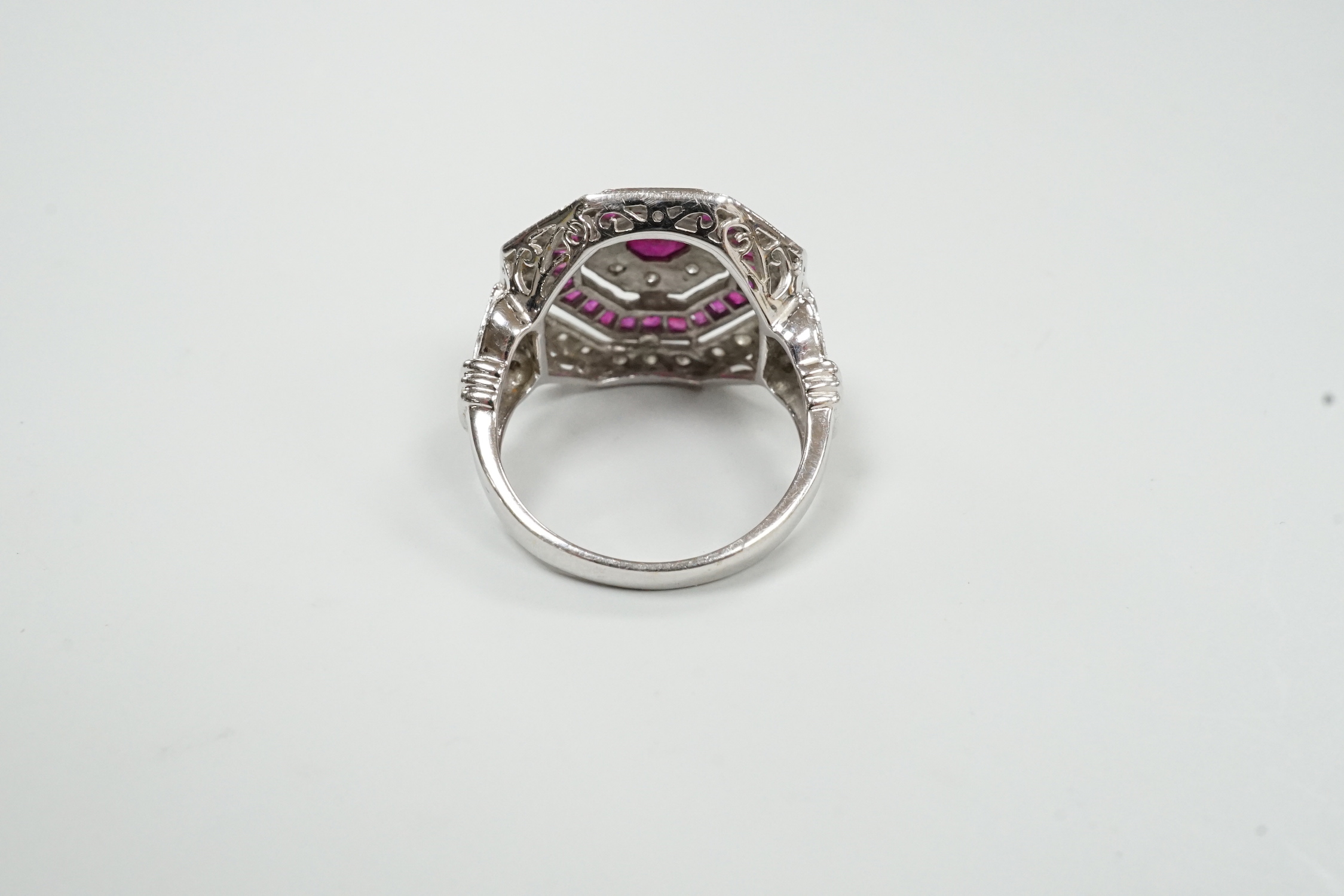 A mid to late 20th century 18ct white gold, ruby and diamond set octagonal cluster target ring, size N/O, gross weight 7.1 grams.